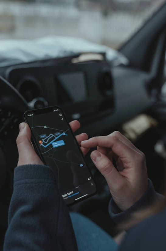 an individual looking at the GPS on a cellular device